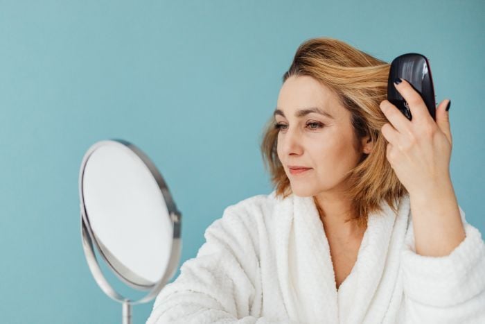 a-woman-combing-her-hair