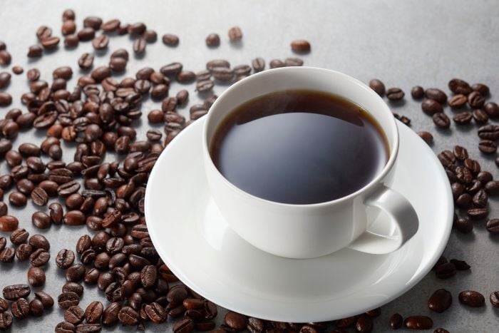 black-coffee-surrounded-by-coffee-beans