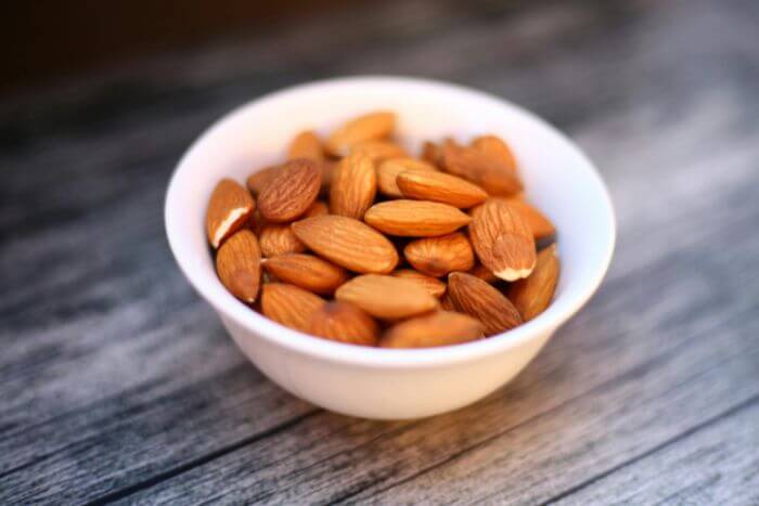brown-almond-nuts-in-white-bowl