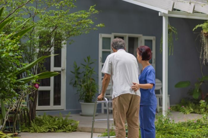 caregiver-help-support-patient-stand-and-walk