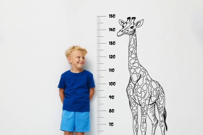 cute-little-boy-measuring-his-height