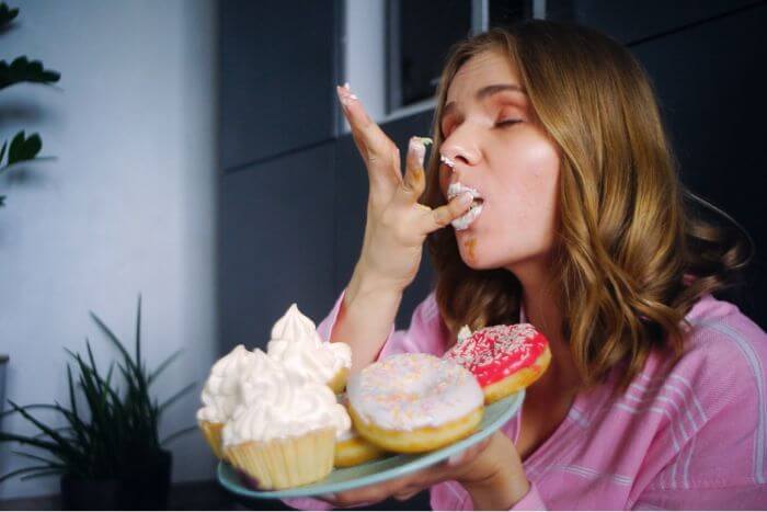 eating-woman-enjoy-cream-cupcake