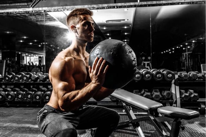 man-doing-medicine-ball-workout-in-the-gym