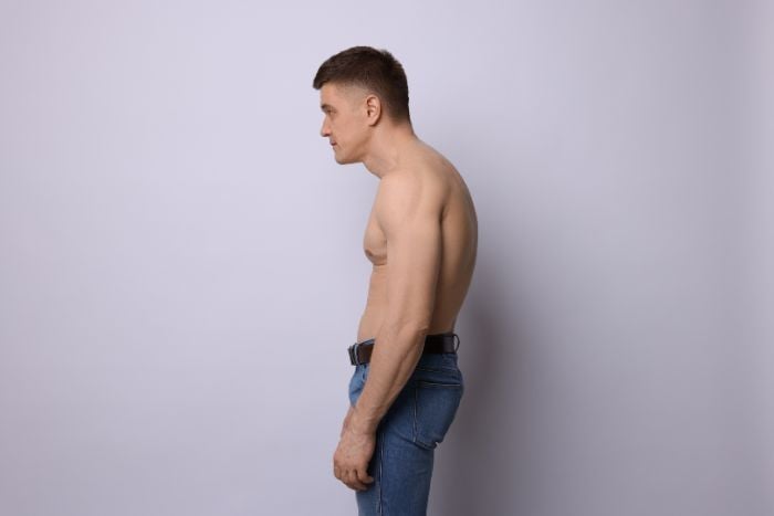 man-with-bad-posture-on-light-background