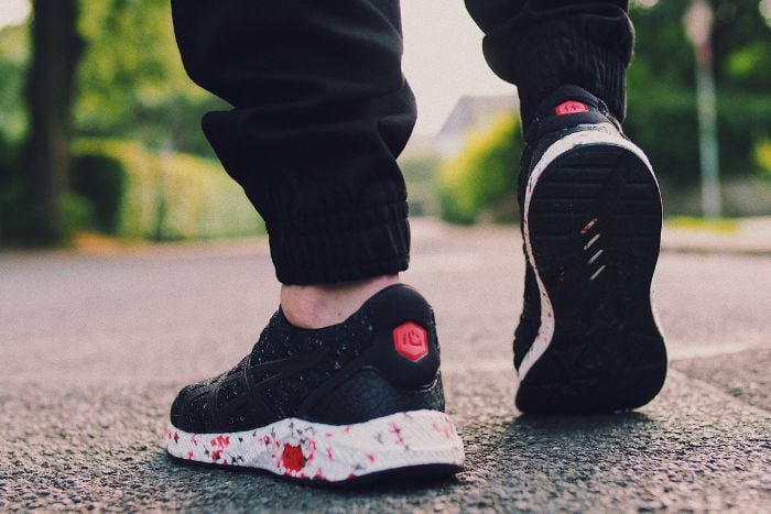 person-in-black-sneakers-walking-on-street