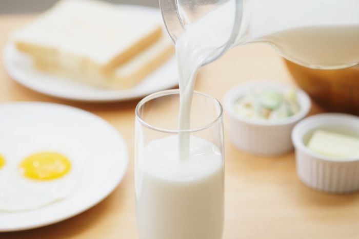 pouring-fresh-milk-into-a-glass-for-breakfast