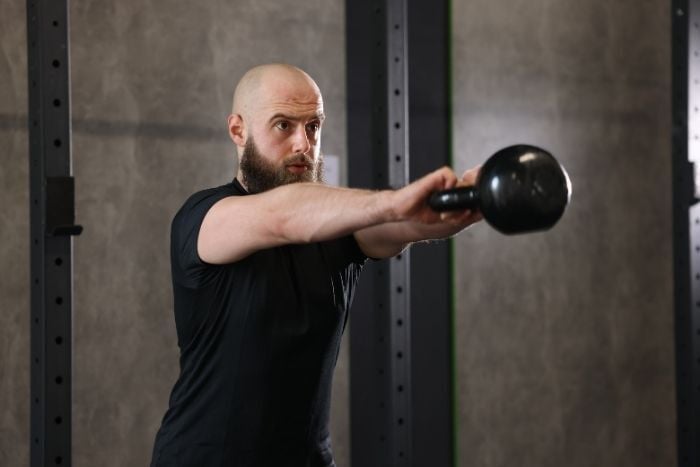 sportsman-doing-kettlebell-swing