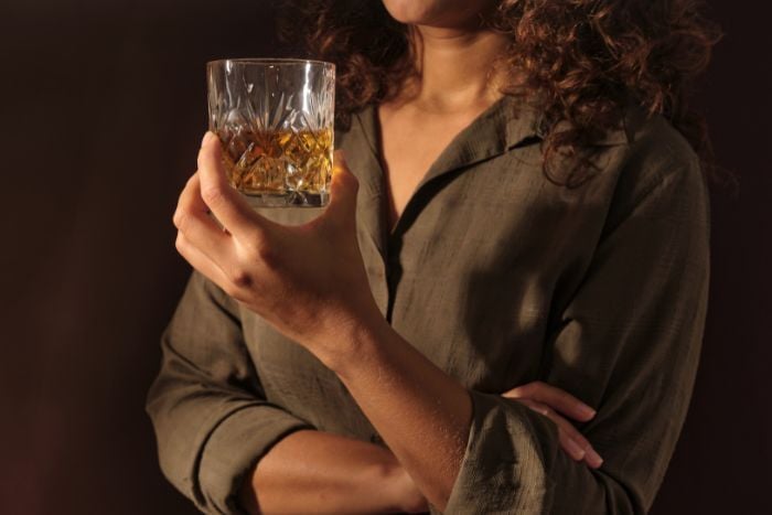 woman-holding-glass-of-whiskey