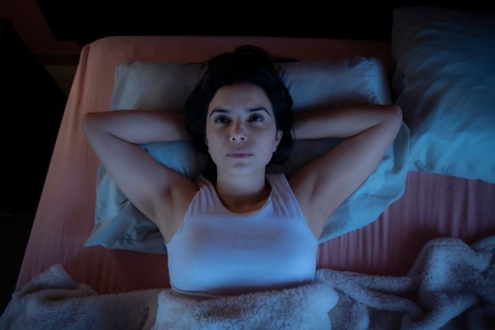 woman-lying-awake-in-bed-at-night-staring-at-ceiling