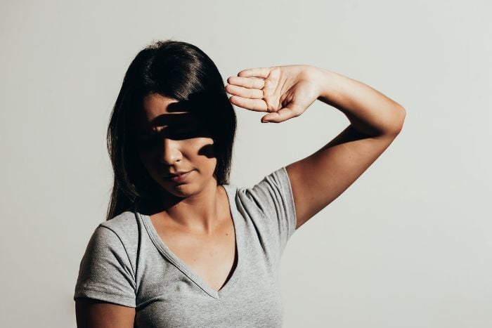 woman-protects-her-eyes-from-bright-light-with-your-hands