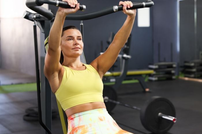 woman-training-on-shoulder-press-machine