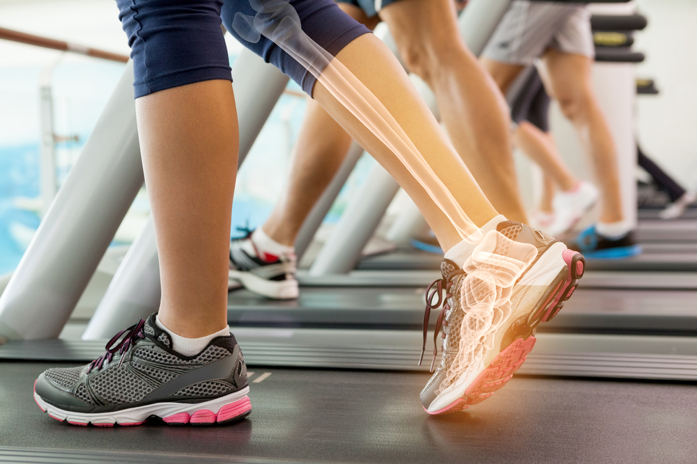 Digital composite of Highlighted ankle of woman on treadmill